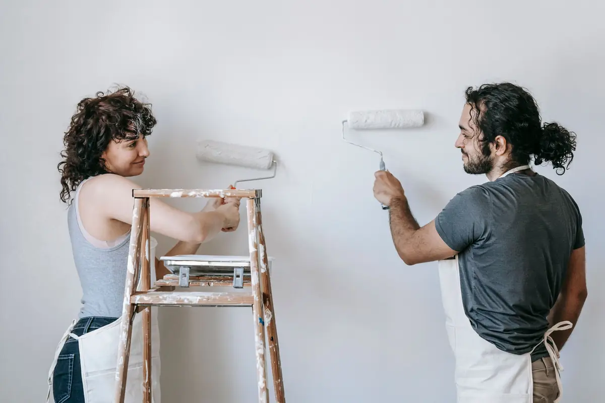 People painting a wall together — painting help in Eugene